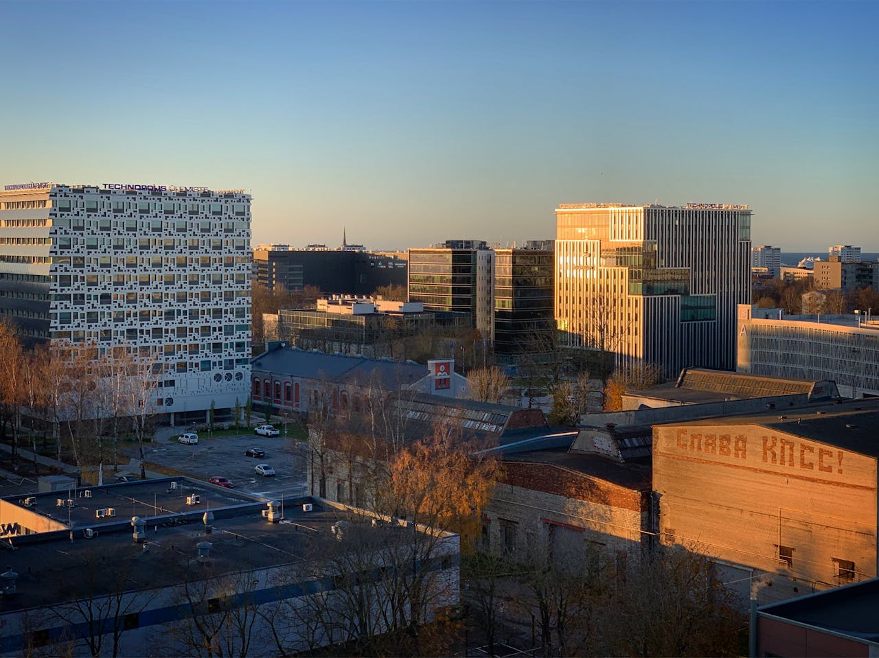 A breathtaking aerial view of Tallinns modern architecture illuminated by dawns golden light.