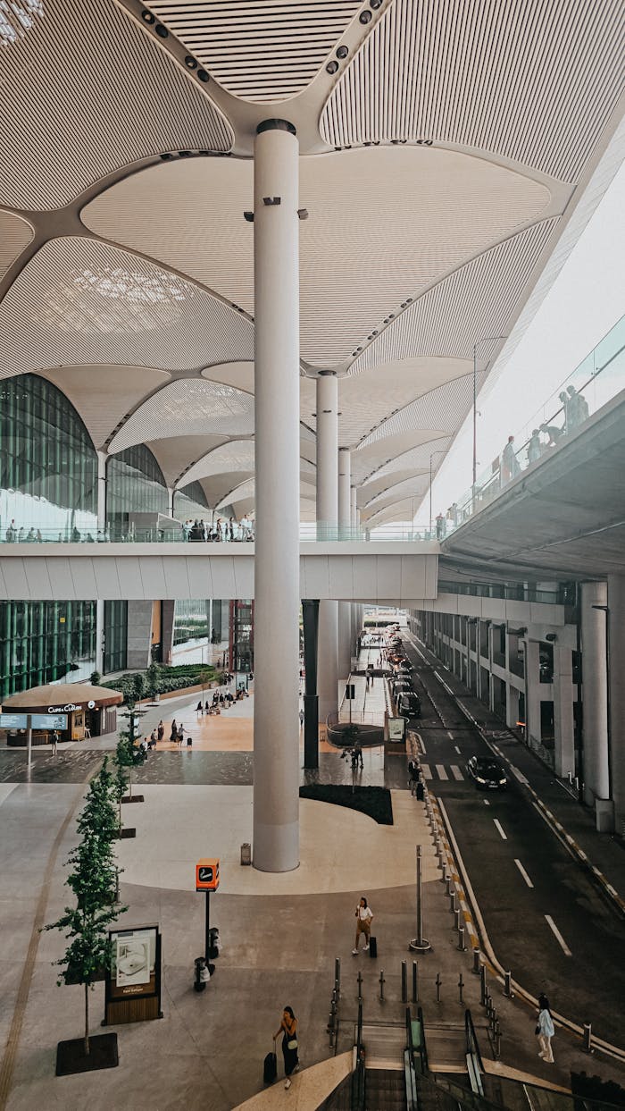 A spacious and modern airport terminal with striking architectural features and natural lighting.